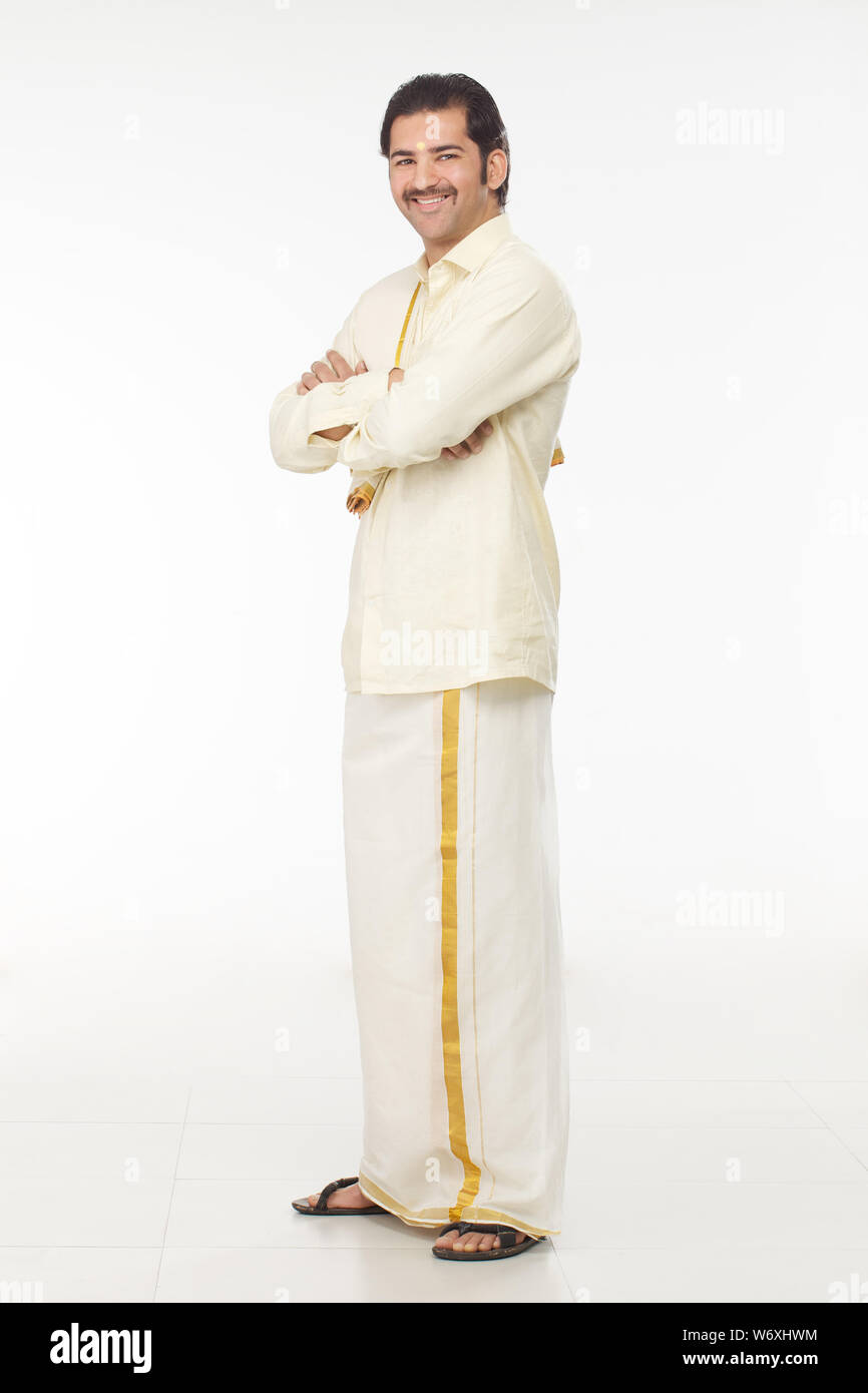 South Indian man standing with his arms crossed Stock Photo - Alamy