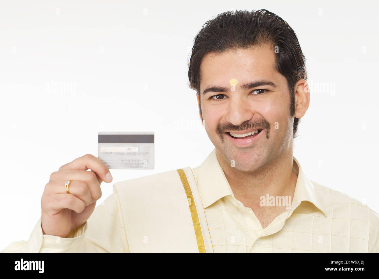 South Indian man showing a credit card and smiling Stock Photo - Alamy