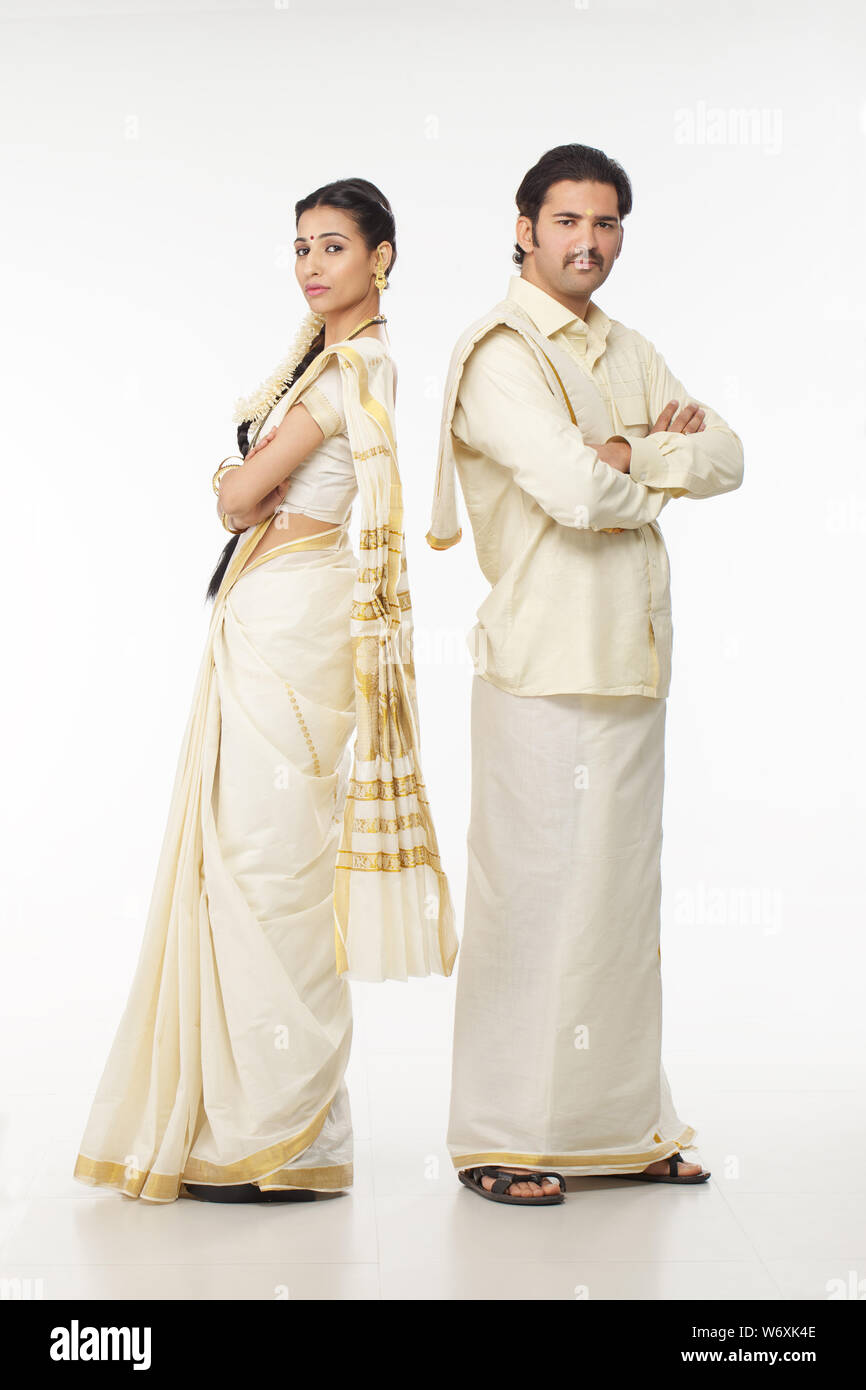 South Indian couple standing back to back Stock Photo - Alamy