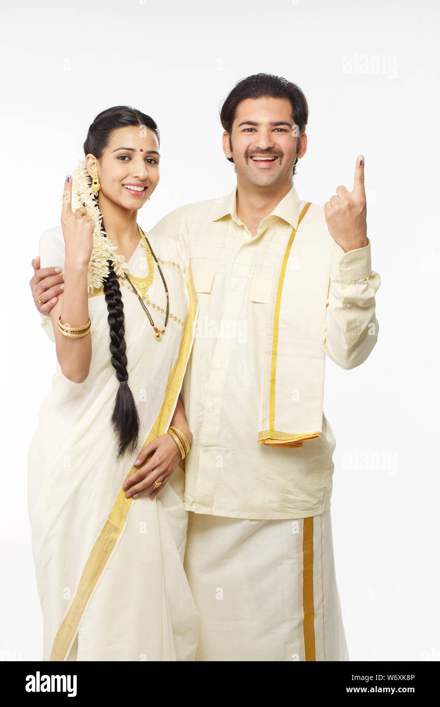South Indian couple standing together and pointing upwards Stock Photo ...