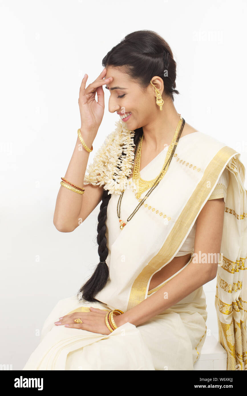 South Indian woman sitting and smiling Stock Photo - Alamy
