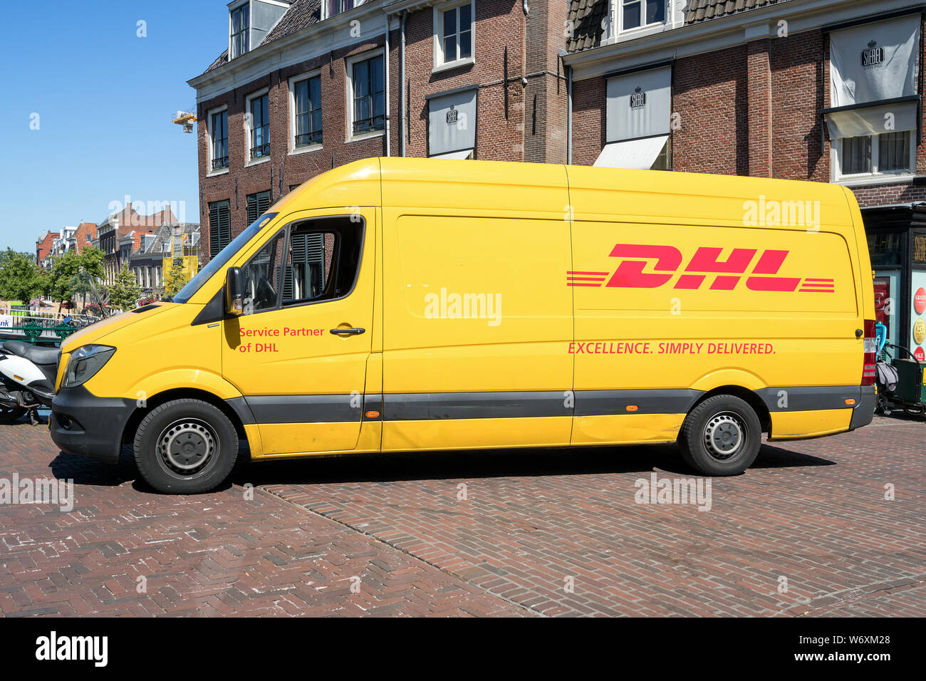 DHL delivery van. DHL is a division of the German logistics company Deutsche Post AG providing international express mail services. Stock Photo