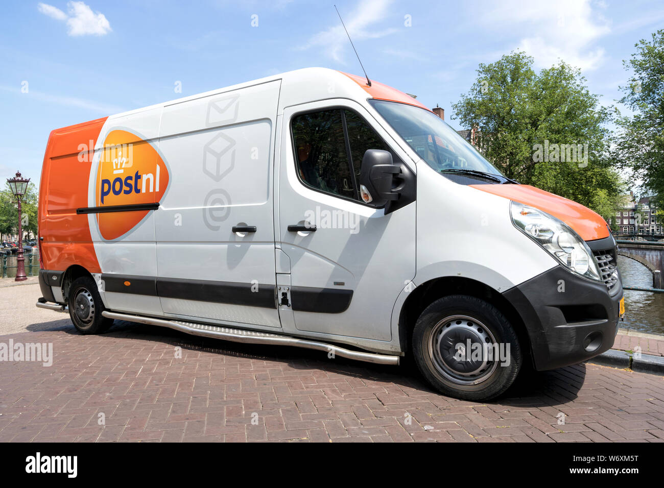 PostNL delivery van. PostNL is a mail, parcel and e-commerce corporation with operations in the Netherlands, Germany, Italy, Belgium, and the UK. Stock Photo