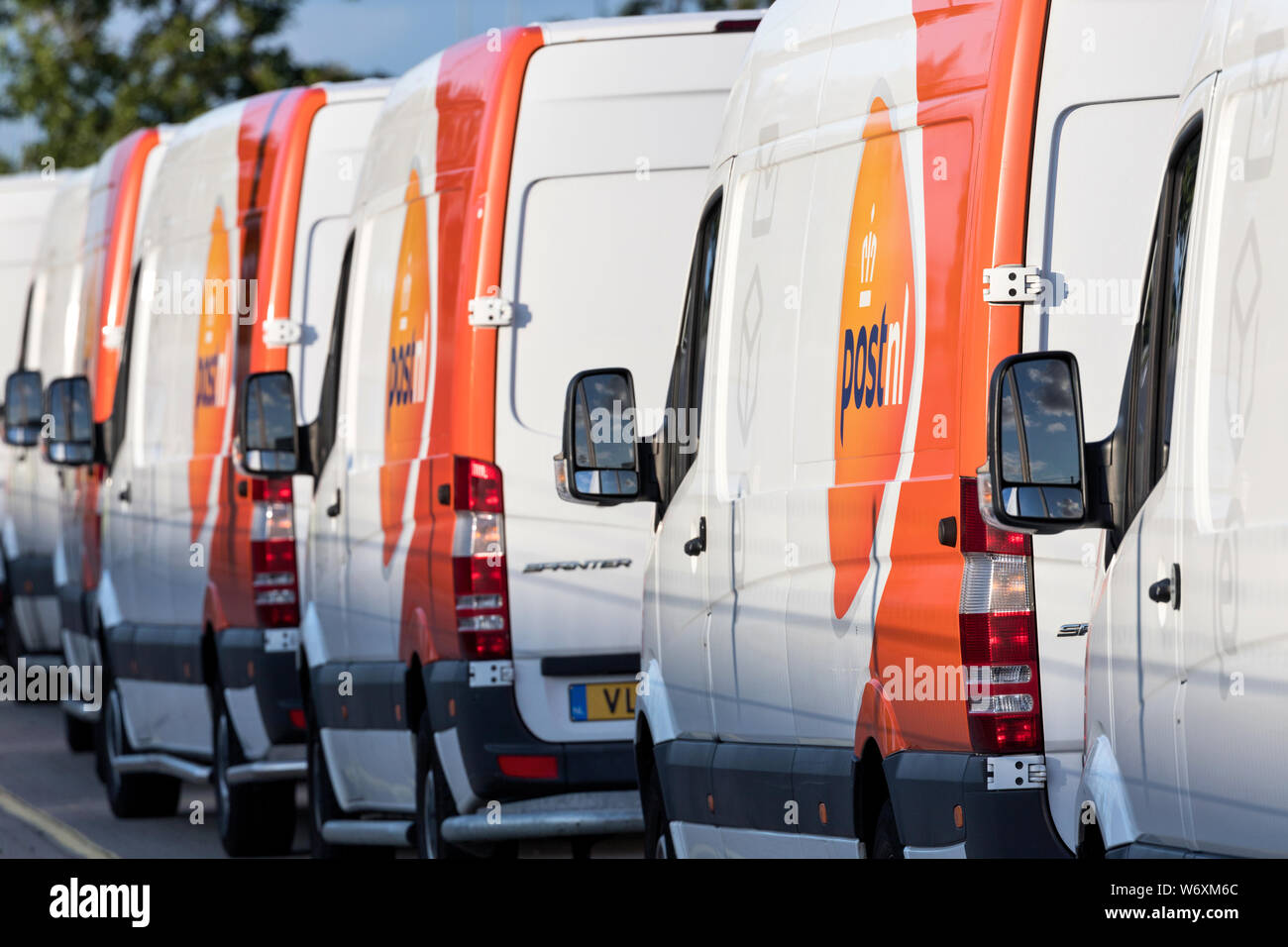 PostNL delivery vans. PostNL is a mail, parcel and e-commerce corporation with operations in the Netherlands, Germany, Italy, Belgium, and the UK. Stock Photo