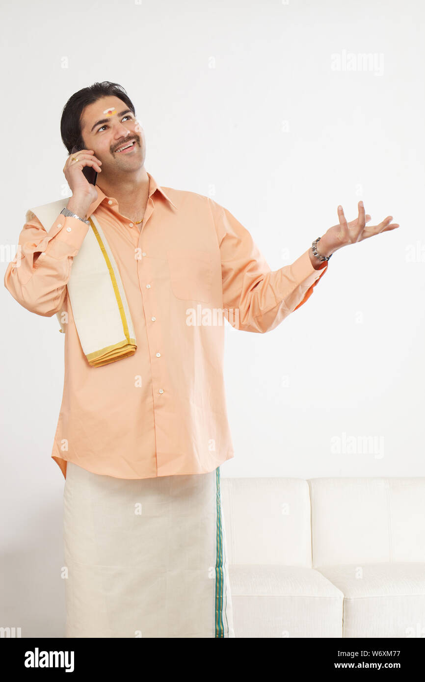 South Indian man talking on a mobile phone Stock Photo