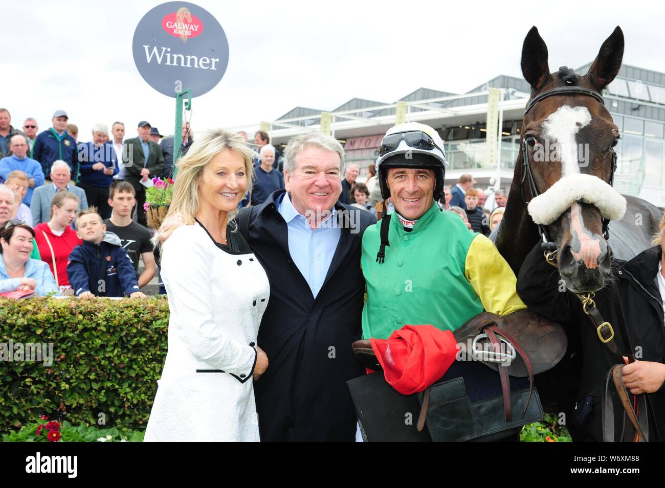Jockey Davy Russell with owners John & Debbie Breslin after winning the O'Leary Insurances Maiden Hurdle onboard Mr Everest during day six of the 2019 Summer Festival at Galway Racecourse. Stock Photo