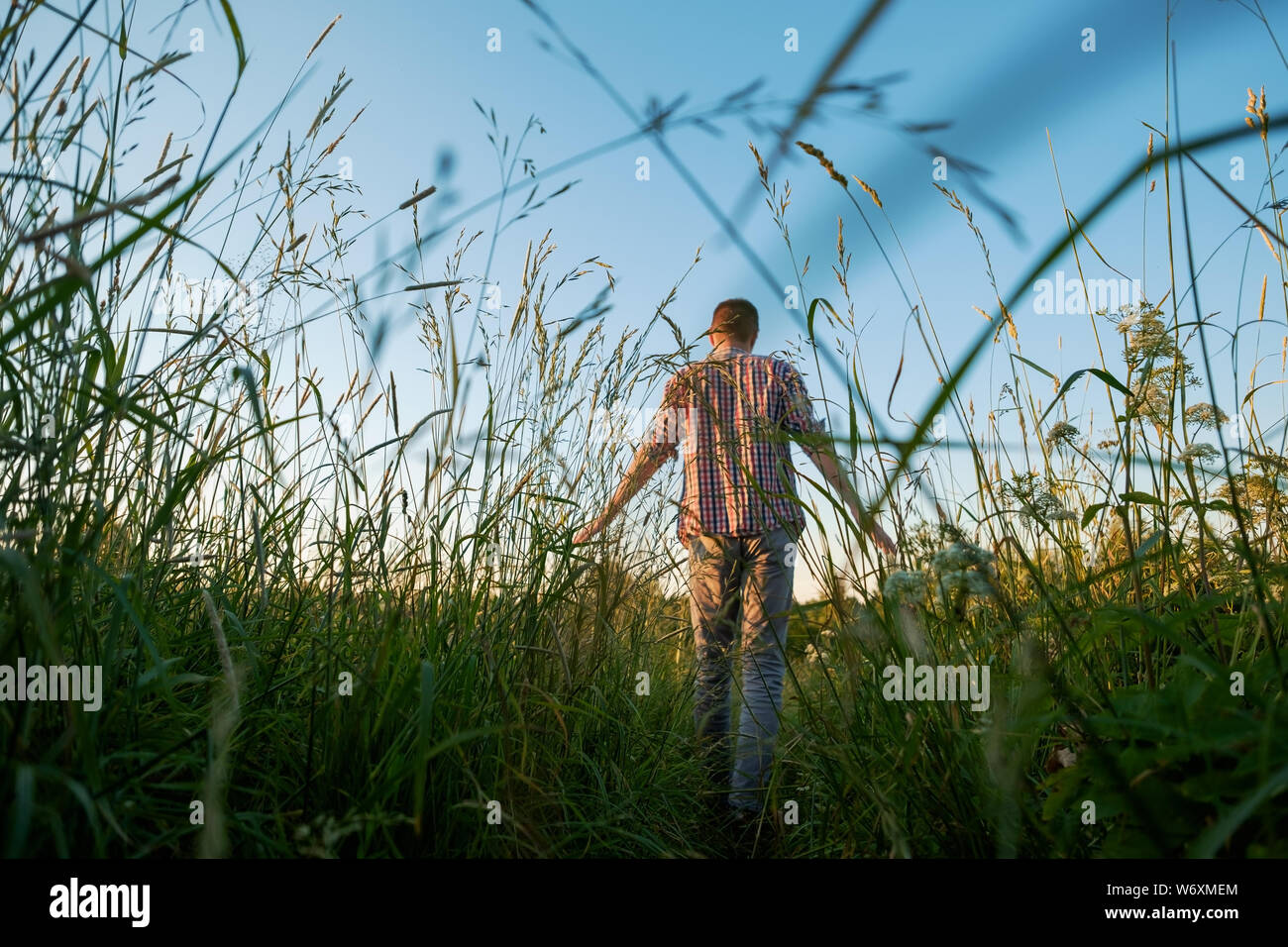 Man alone in field in hi-res stock photography and images - Alamy