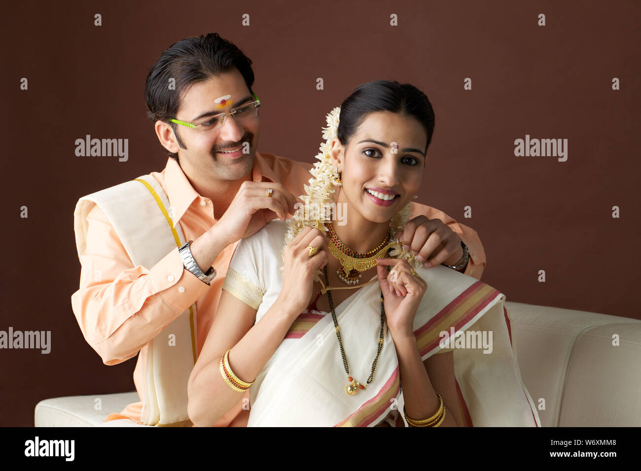 South Indian man carrying shopping bags with his wife showing credit card  Stock Photo - Alamy