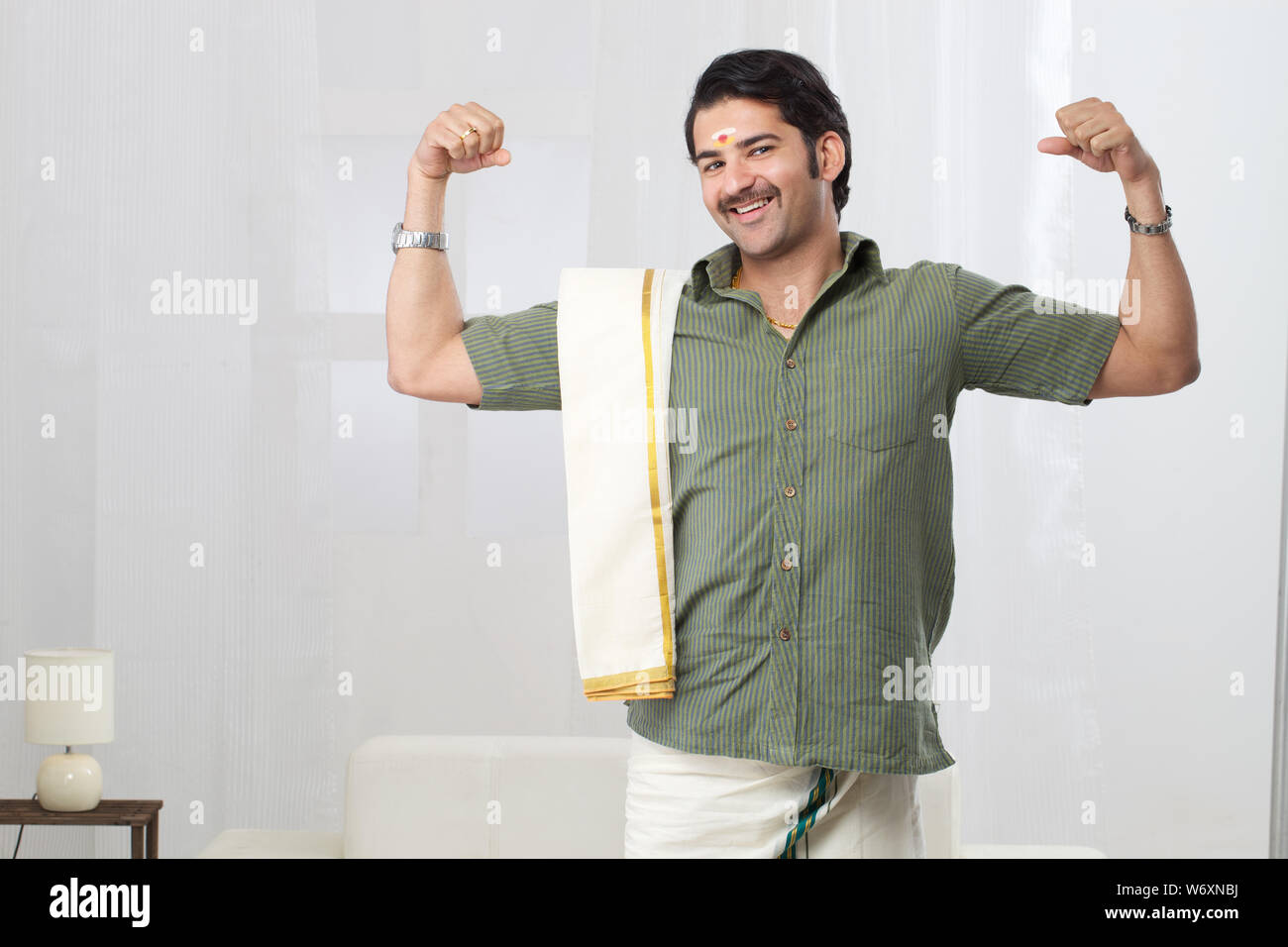 South Indian man showing his biceps Stock Photo - Alamy