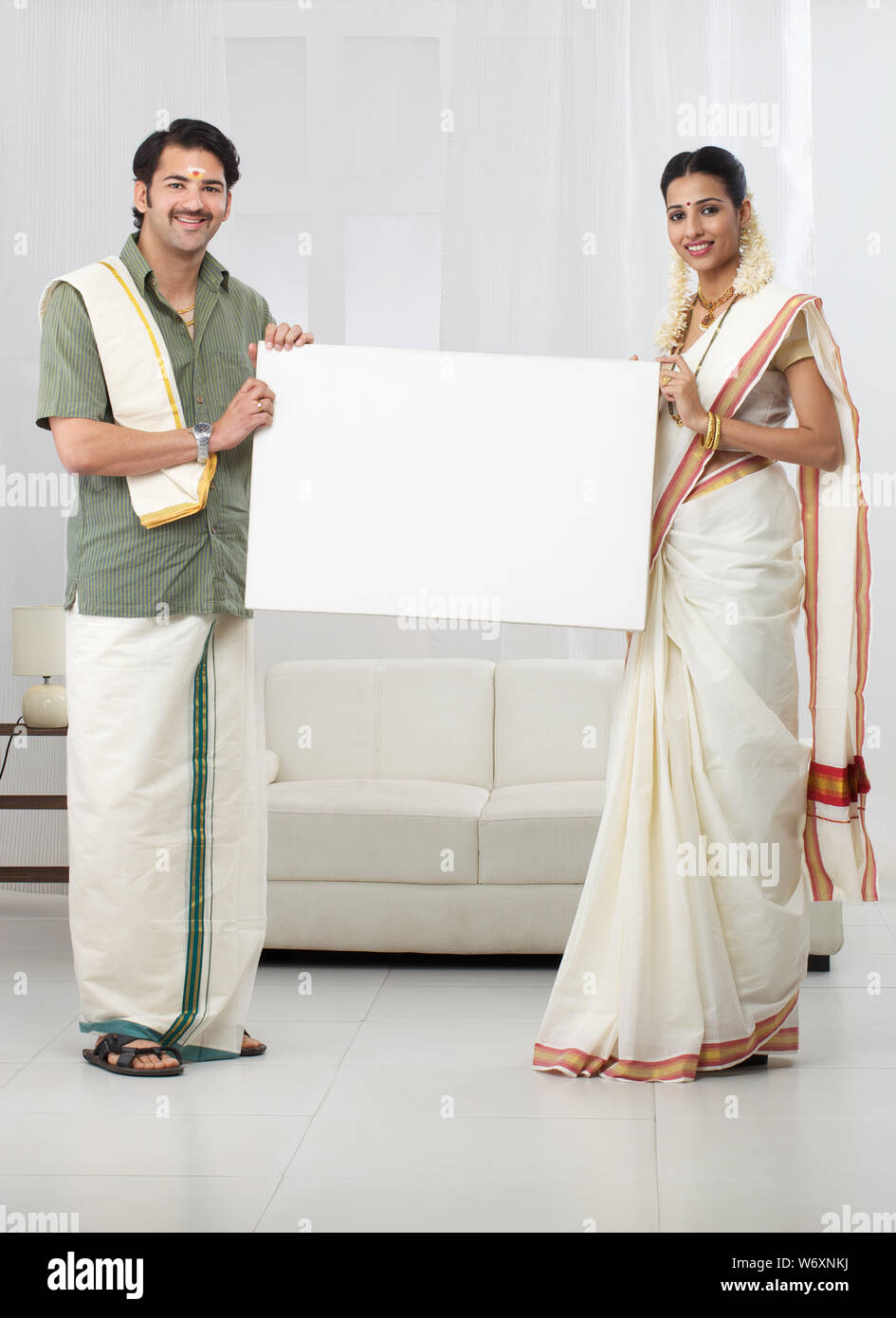 South Indian couple showing a blank placard Stock Photo