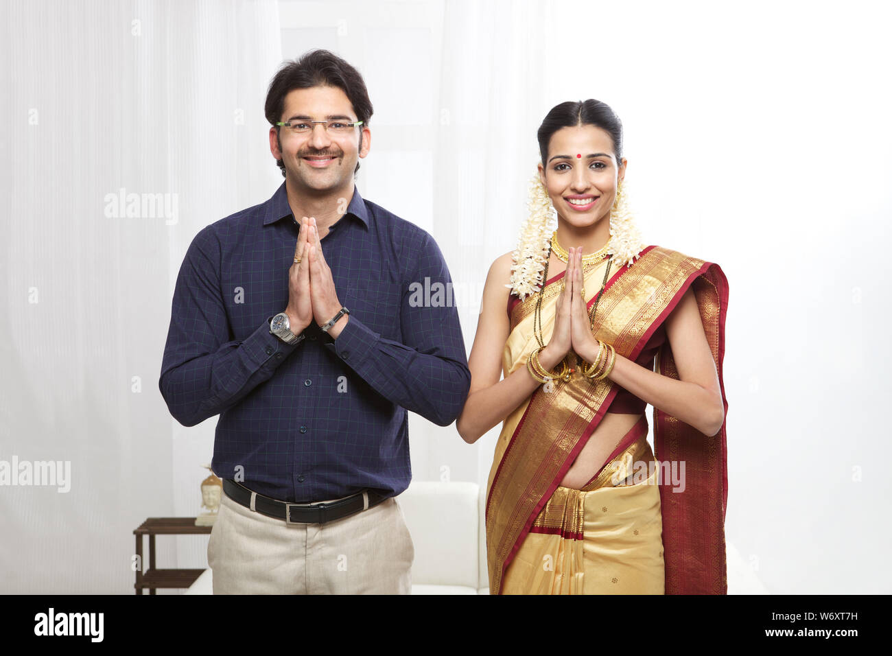 South Indian couple standing with hands joined Stock Photo - Alamy