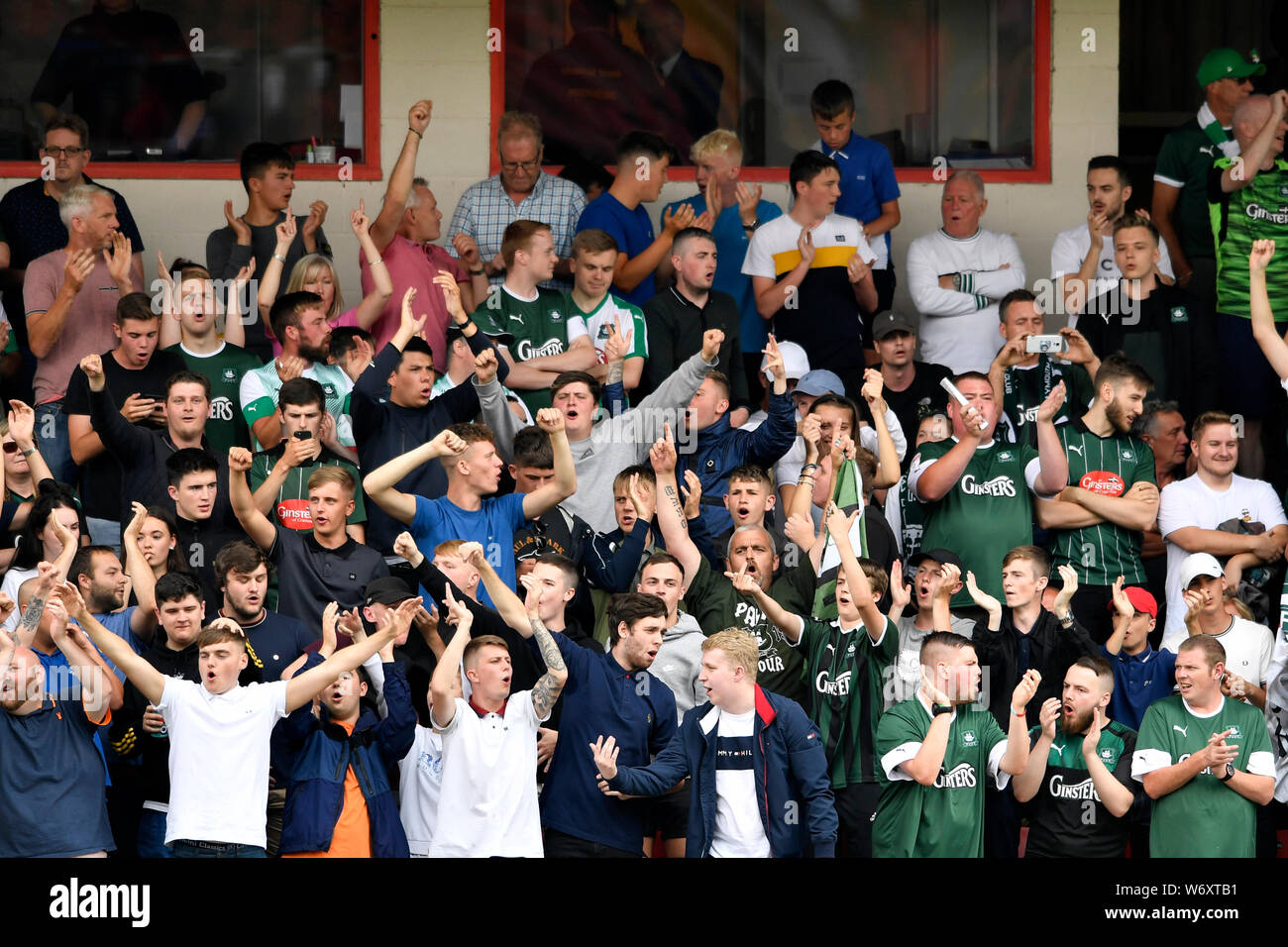 Alexandra Stadium, Crewe, Cheshire, UK. 3rd Aug, 2019. Football Sky Bet League 2 Crewe Alexandra versus Plymouth Argyle; The travelling Plymouth Argyle fans cheering their team : EDITORIAL USE ONLY. No use with unauthorized audio, video, data, fixture lists, club/league logos or 'live' services. Online in-match use limited to 75 images, no video emulation. No use in betting, games or single club/league/player publications. Credit: Action Plus Sports/Alamy Live News Stock Photo
