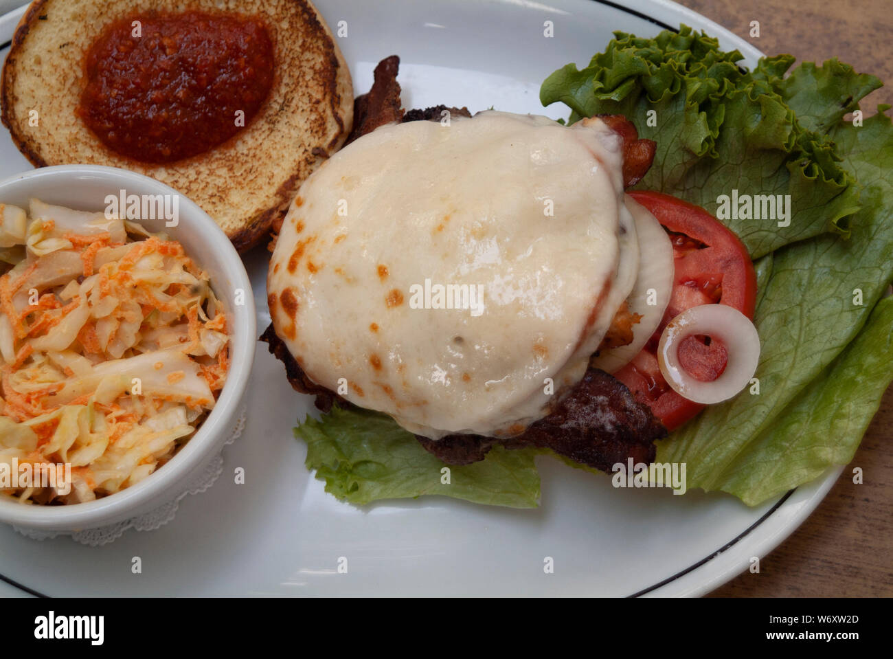 KING BEEF: A gourmet bacon cheeseburger with a rare horse radish spread is served up for a lunch meal at a restaurant in a Savannah, Georgia. Stock Photo
