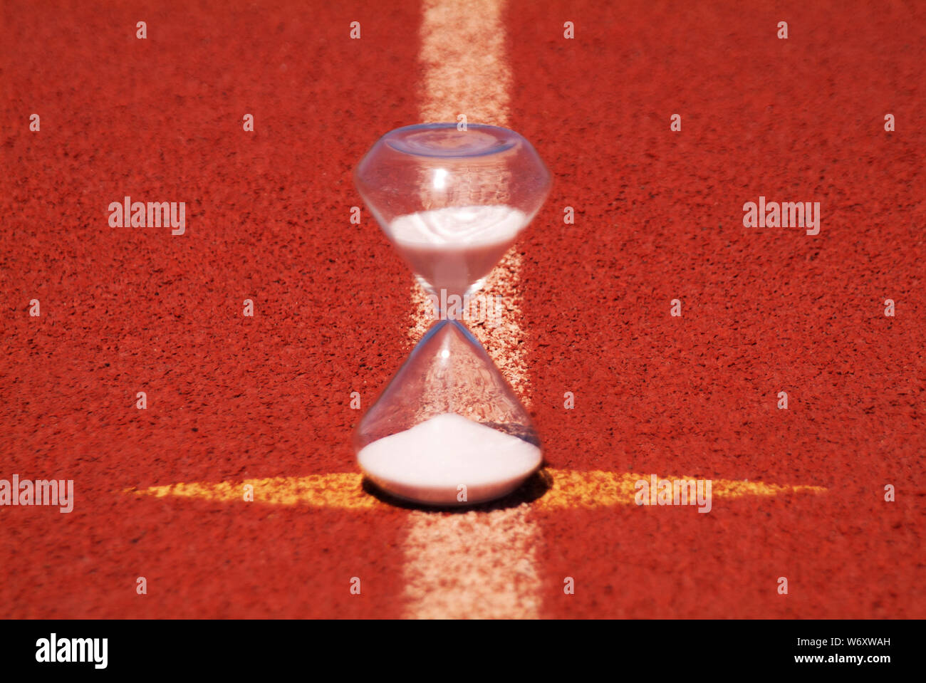 TIMELINE: An hourglass sits on a high school racetrack. Stock Photo