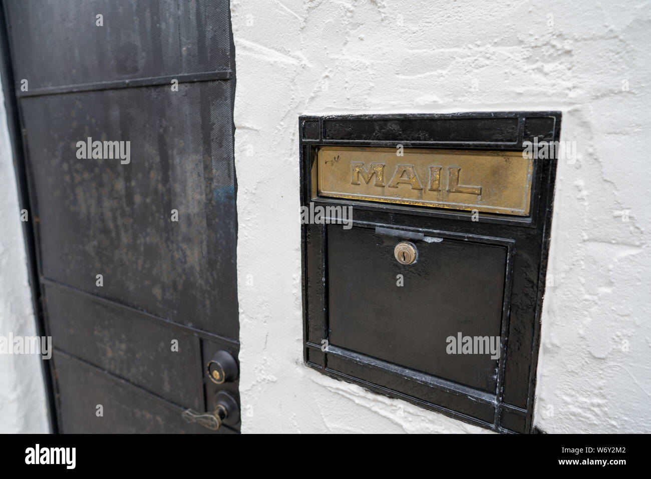 Black mail slot and lock outside of door of building Stock Photo Alamy