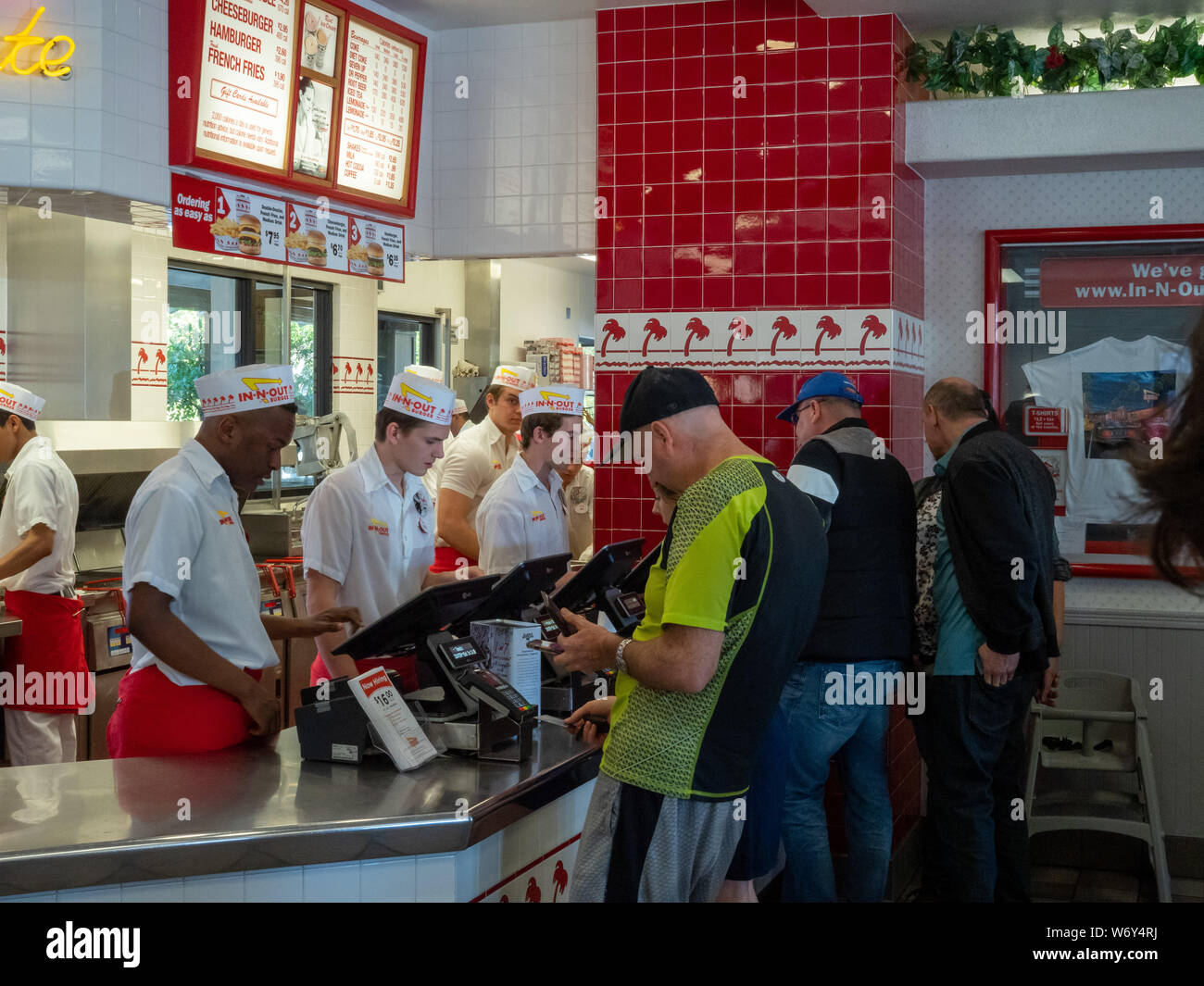 Diners lined up behind cashier and checkout counter at In-N-Out Stock Photo