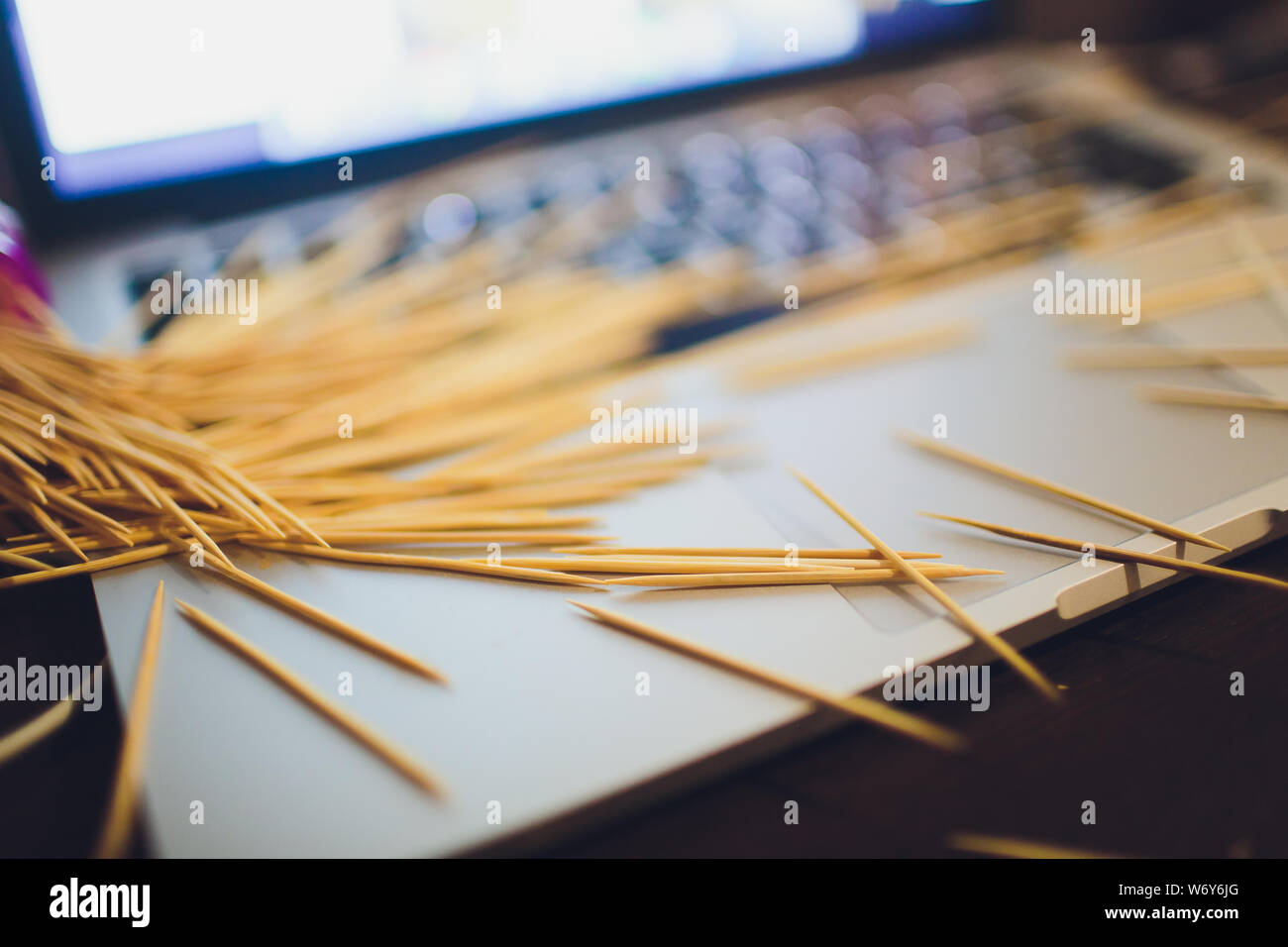 many wooden toothpicks on the brown table background a laptop Stock ...
