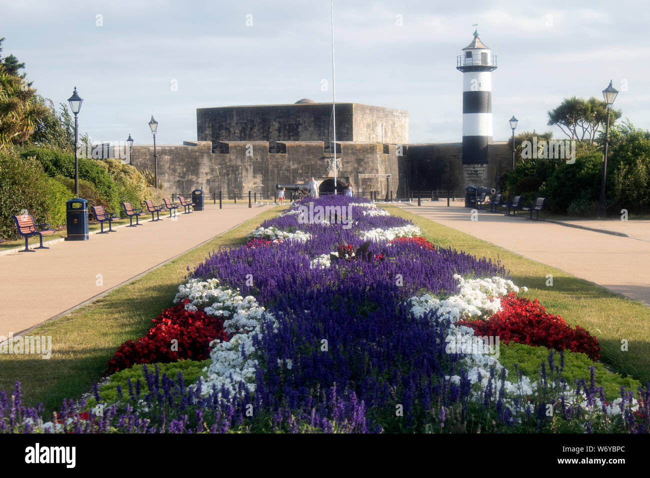 Southsea Castle Lighthouse on Clarence Esplanade, with the flowebed from the D-Day museum in the foreground Southsea, Portsmouth, Hampshire, UK Stock Photo