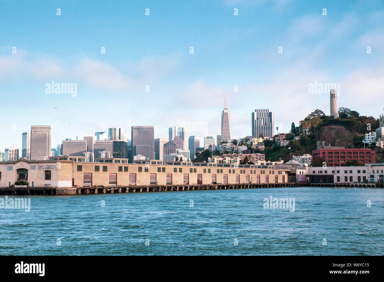 City of San Francisco California seen from the Bay with boats, docks, wharf and buildings of skyline in view. Stock Photo