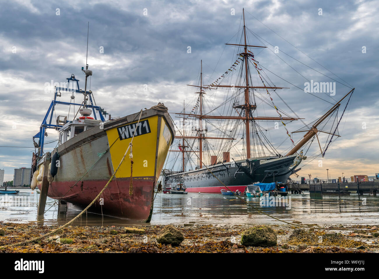 Portsmouth, Hampshire, England. Saturday 3 August 2019. UK Weather. After a warm and humid day in Portsmouth, Hampshire, clouds start to build on the south coast of England as HMS Warrior basks in the intermittent hazy sunshine. Warrior was the largest, fastest and most powerful warship in the Royal Navy when launched in 1860. Stock Photo