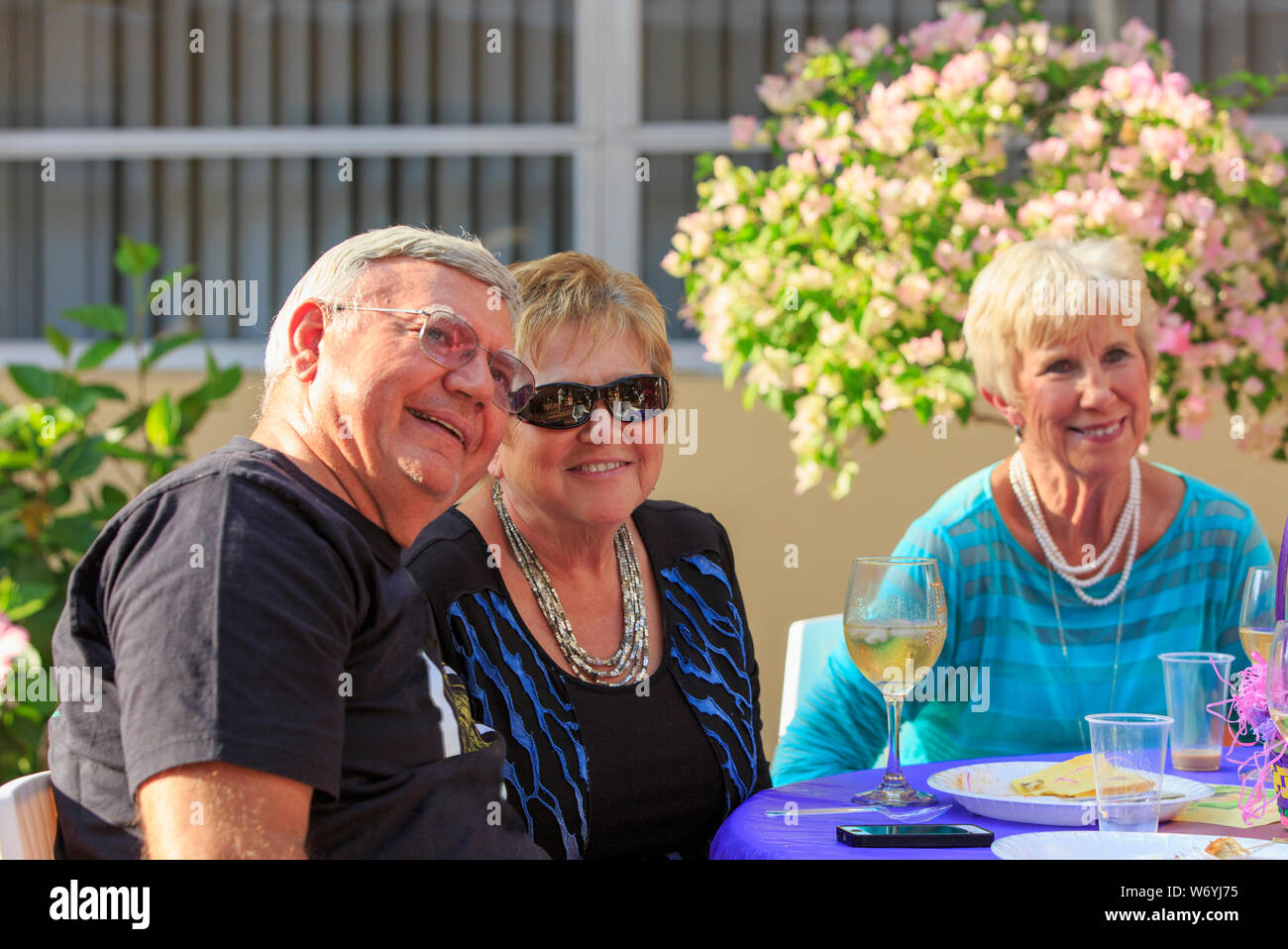 Happy senior people sitting at dinner outside Stock Photo