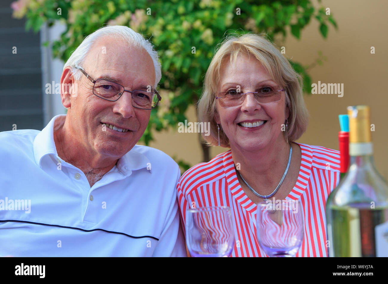 Portrait of senior couple sitting at dinner outside Stock Photo
