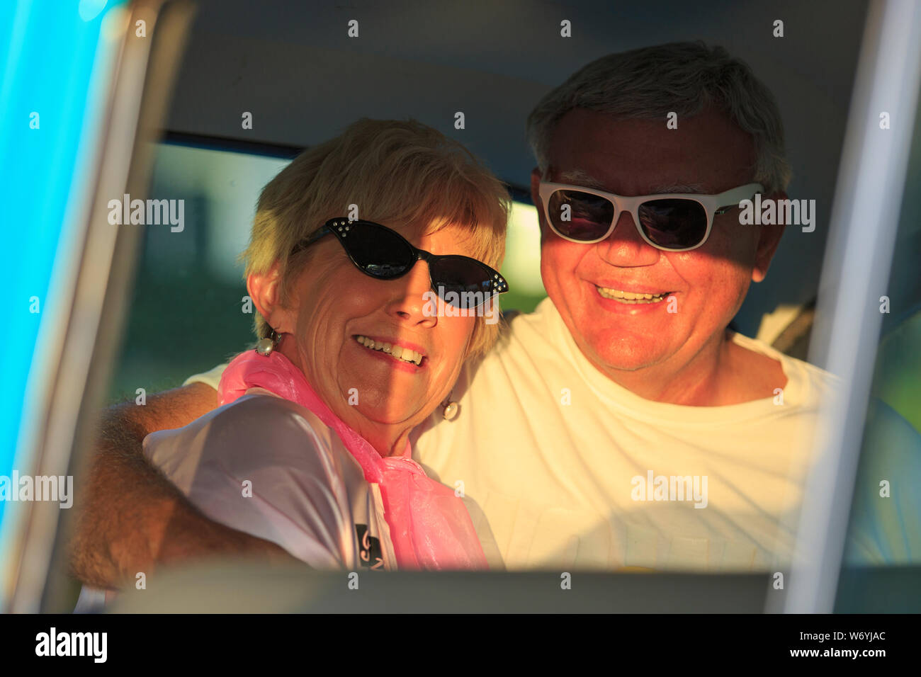 Portrait of happy senior couple sitting in a car Stock Photo