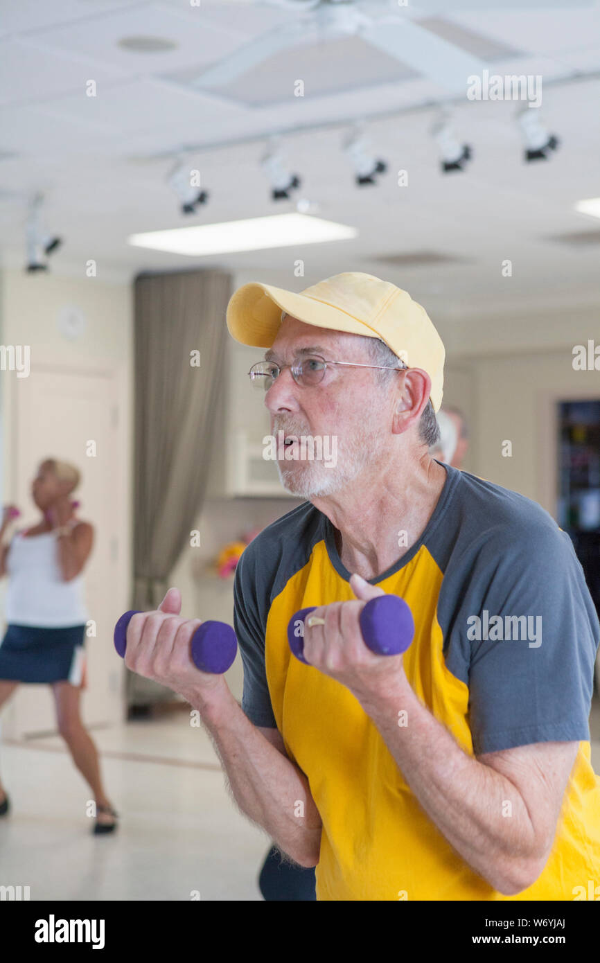 Senior man exercising in gym Stock Photo