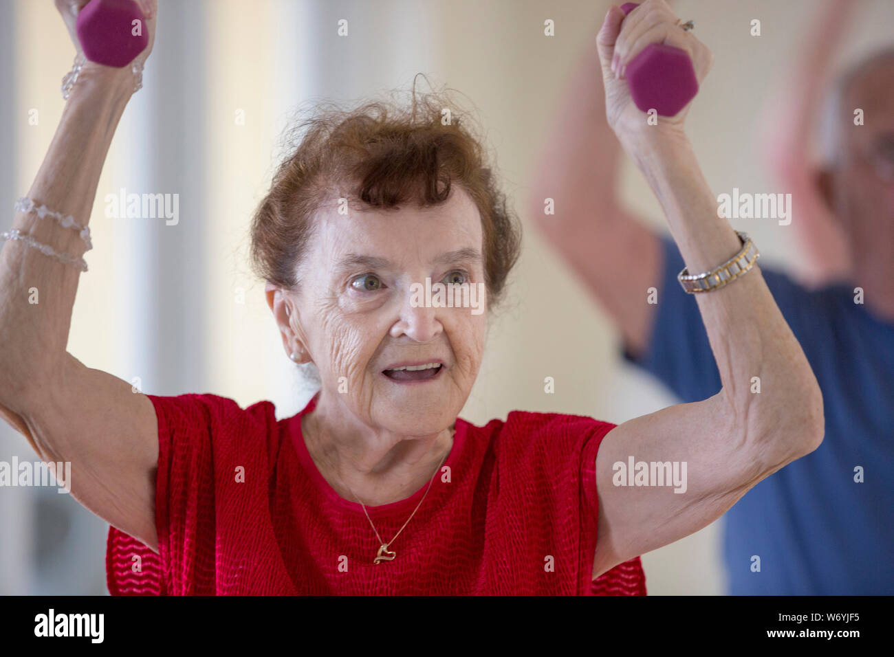 Senior woman exercising in gym Stock Photo