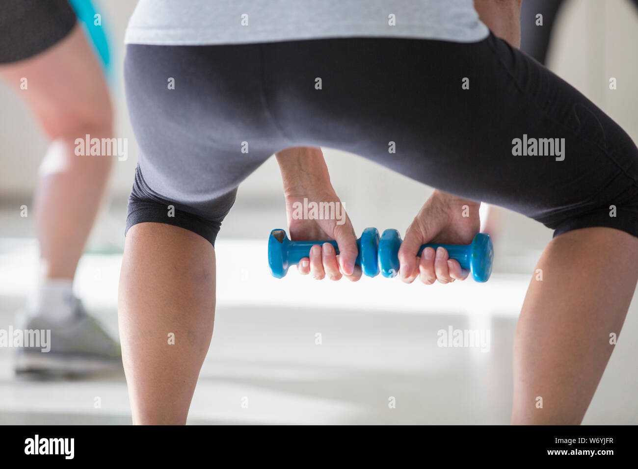 Mid section of senior woman exercising in gym Stock Photo