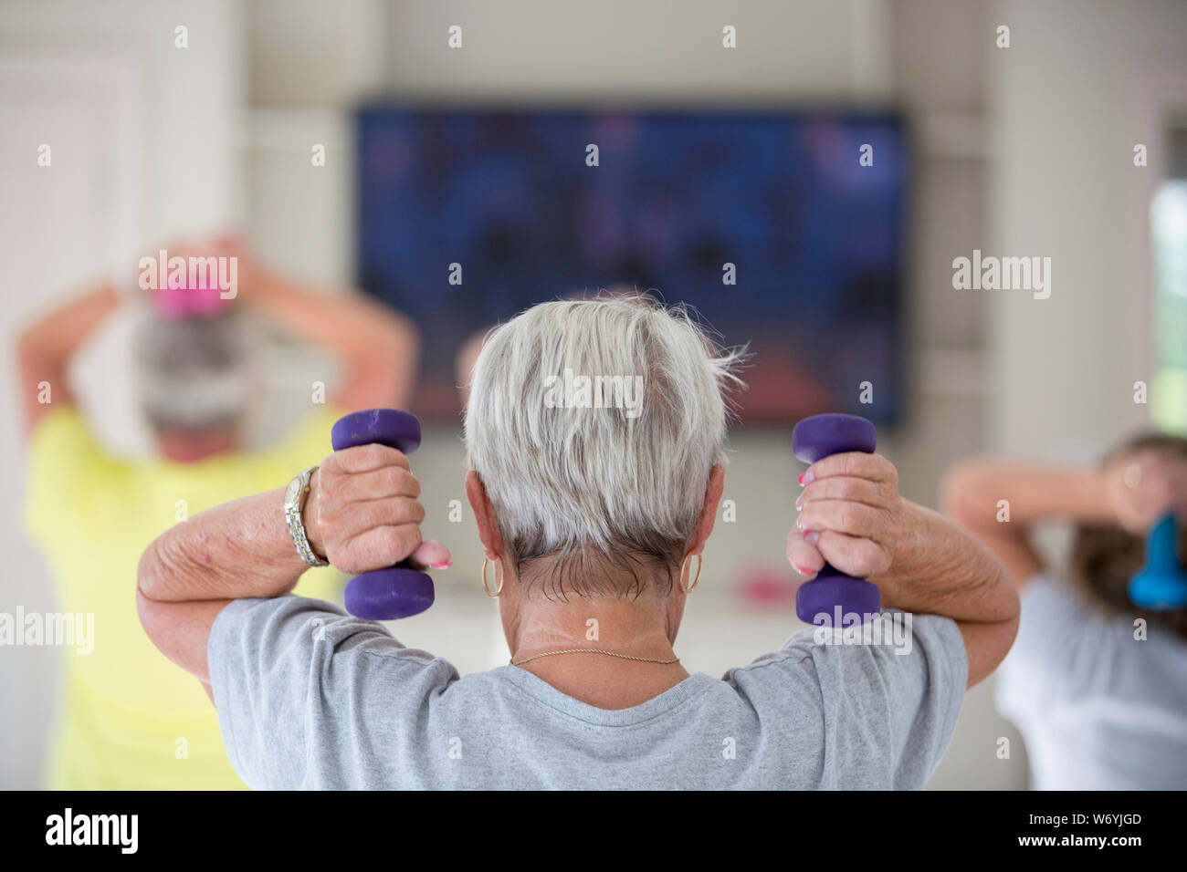 Rear view of senior woman exercising in gym Stock Photo