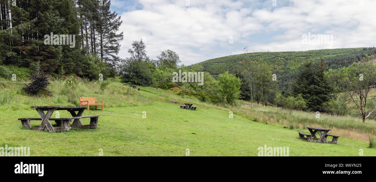 Wales countryside view of picnic benches in Hafren Forest park in summer Stock Photo