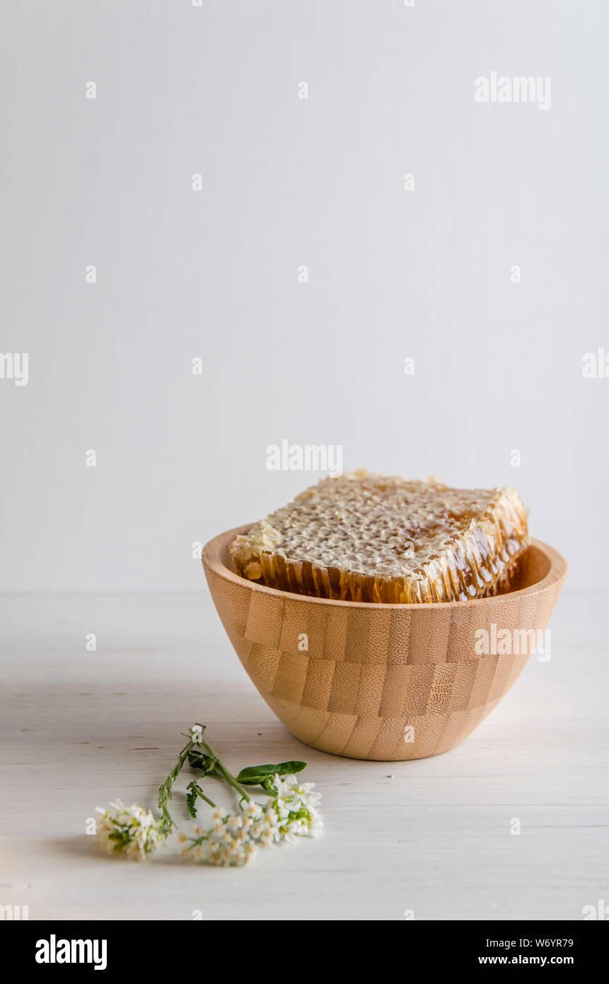 fresh honeyt in wooden utensils on a white wooden background with copy space Stock Photo