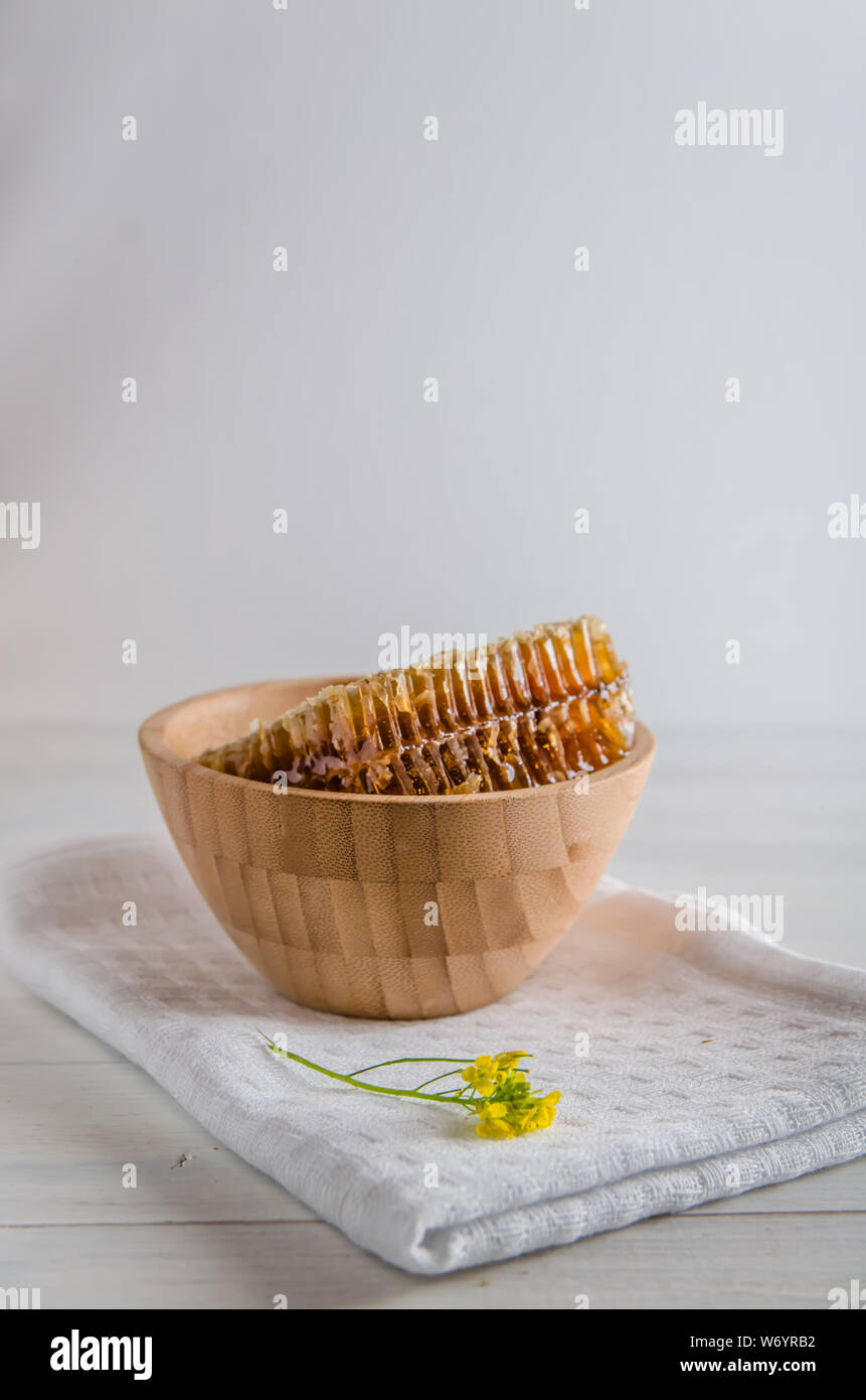 fresh honeyt in wooden utensils on a white wooden background with copy space Stock Photo