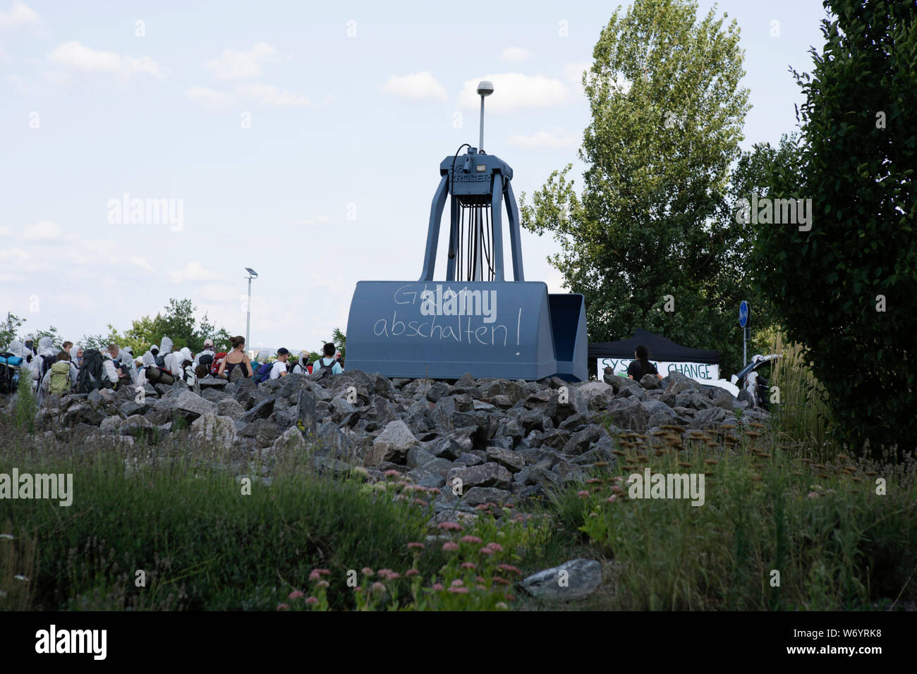 Mannheim, Germany. 3rd August 2019. 'Switch off Mannheim Power Plant' has been written on the excavator shovel that stands as a monument in front of the power plant. Activists from the Ende Gelande organisation have occupied the coal conveyor belt on the large coal power plant in Mannheim. They also block the main entrance of the plant, calling for an end to the use of coal in energy production and the use of renewable energy sources. Stock Photo