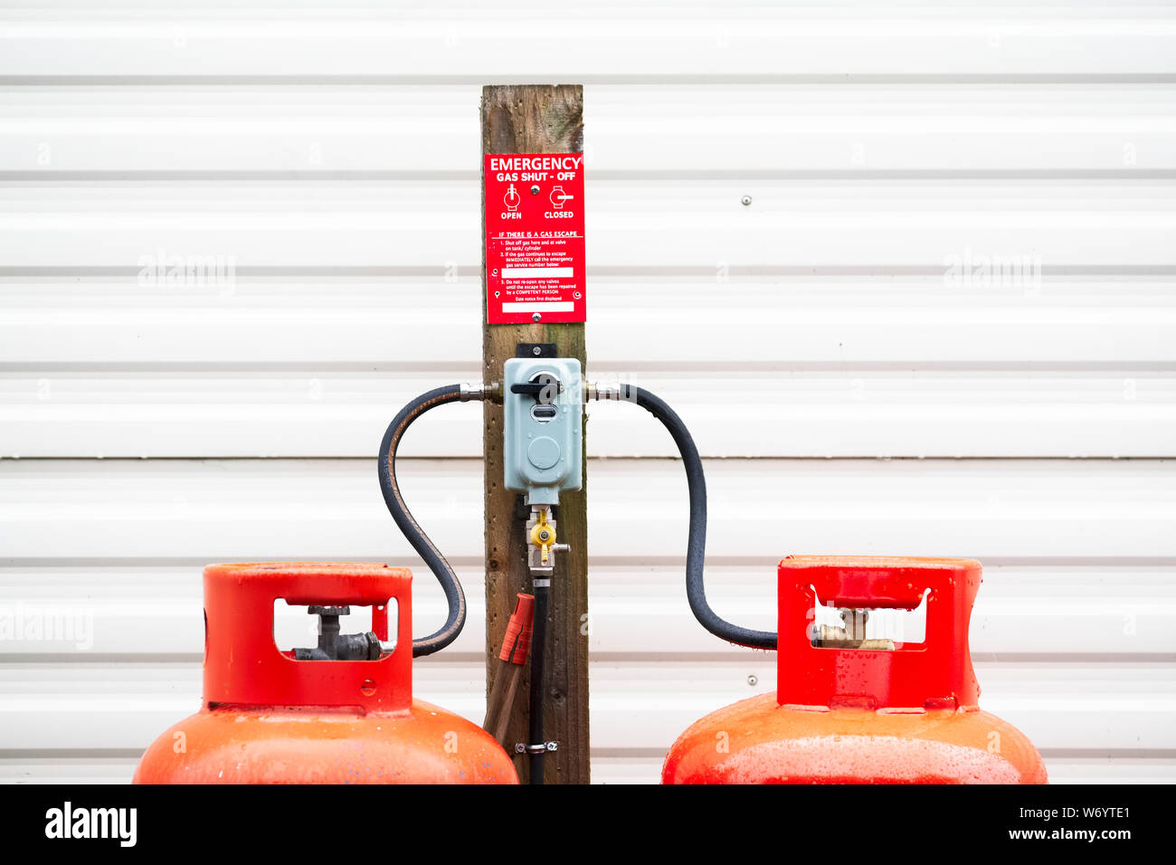 Calor gas cylinder bottles refilling with hose at refill point within  caravan park site Stock Photo - Alamy