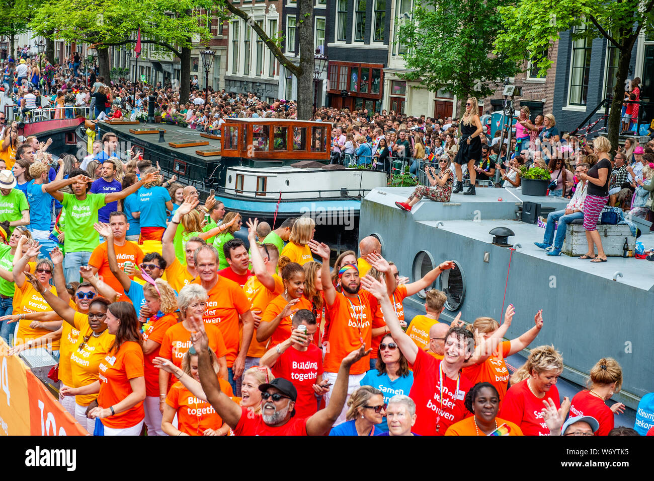 A Group Of People Wearing Colourful Clothes Are Seen On A Boat During The Parade The Canal