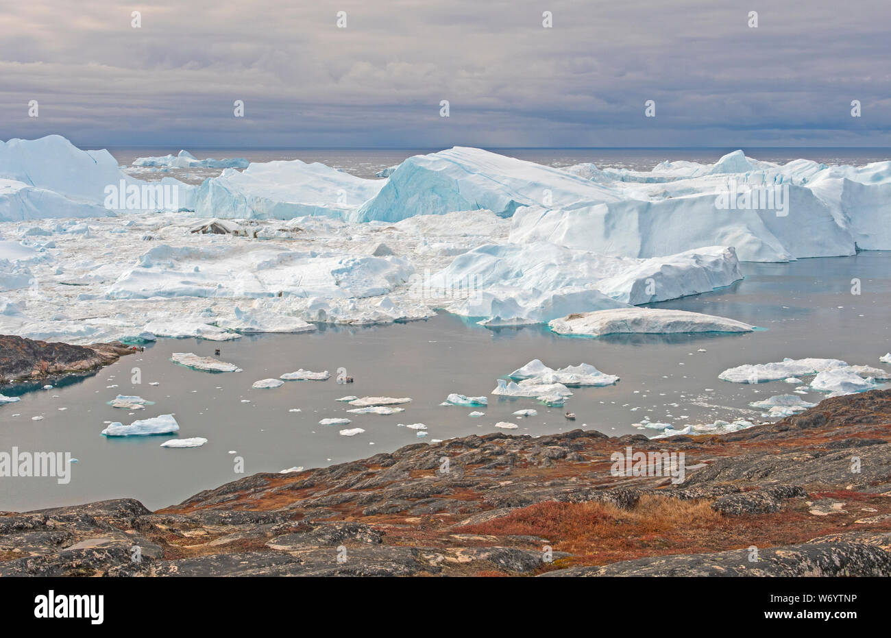 Icebergs Heading out to the Ocean by the Icefjord of Ilulissat, Greenland Stock Photo