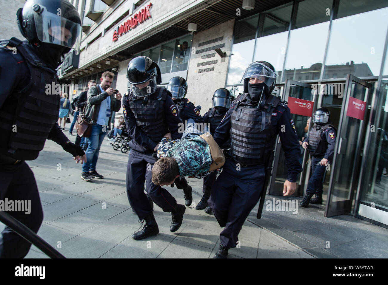 Police officers detain a man during an unsanctioned rally in the centre of Moscow, Russia.Moscow police detained more than 300 people who were protesting against the exclusion of some independent and opposition candidates from the city council ballot, a monitoring group said. Stock Photo