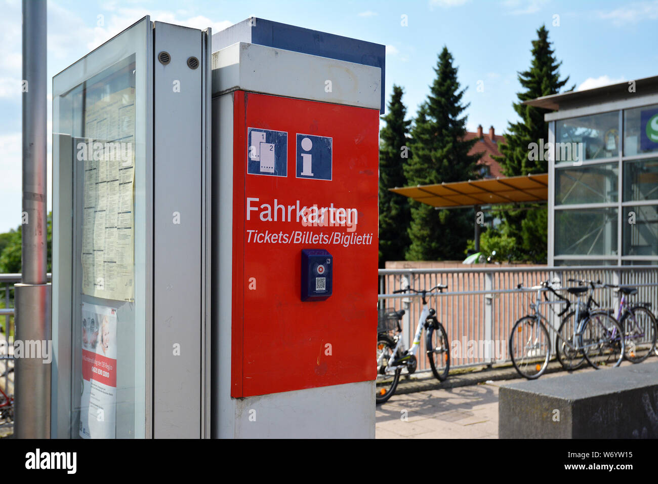 Heidelberg, Germany - August 2019:  Red German train ticket machine and timetable at railroad station Stock Photo
