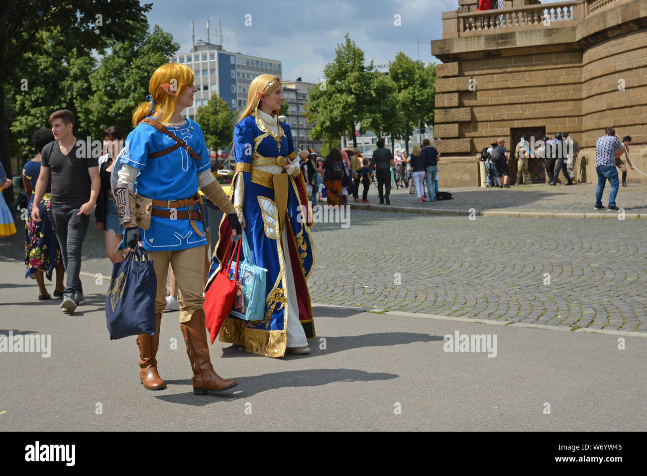 Mannheim, Germany - August 2019: Cosplayers walking by at public park in front of water tower in Mannheim during anual anime and manga convention Stock Photo