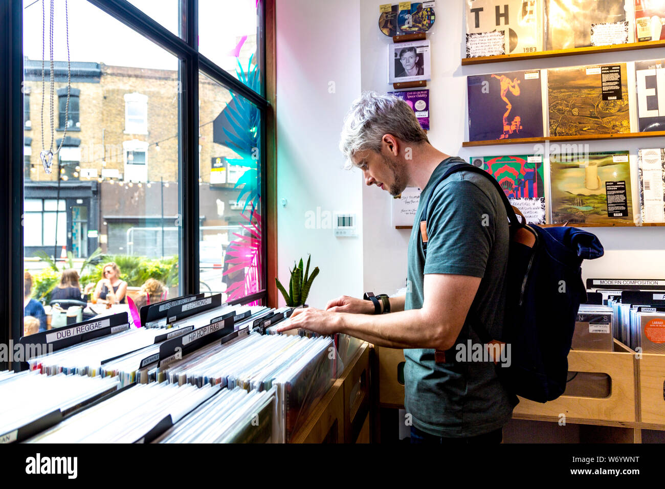 Man browsing vinyl records at Stranger Than Paradise record shop, Mare Street Market, London, UK Stock Photo