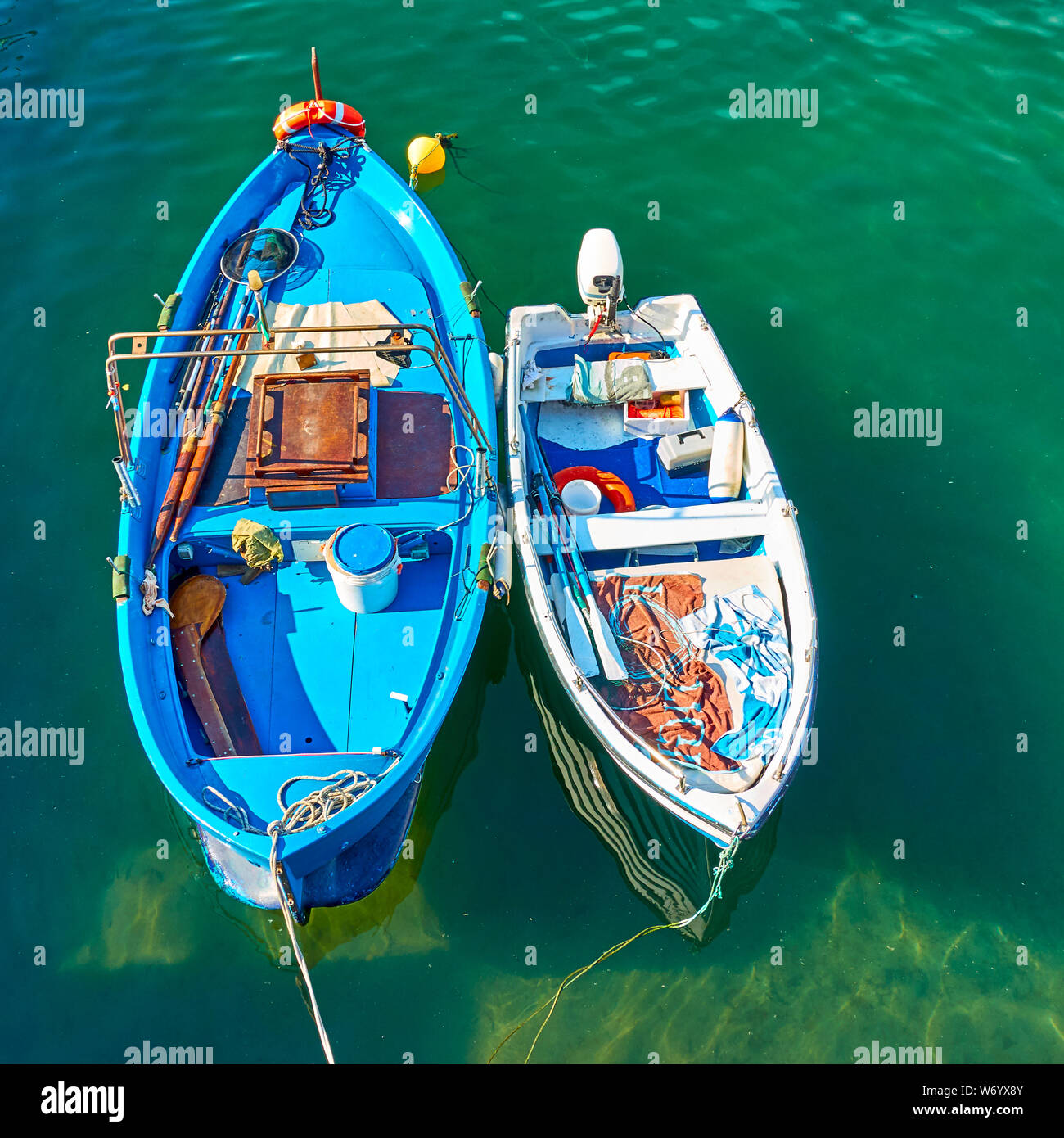 Oar fishing boat and small motorboat with outfit for sea fishing inside  Stock Photo - Alamy