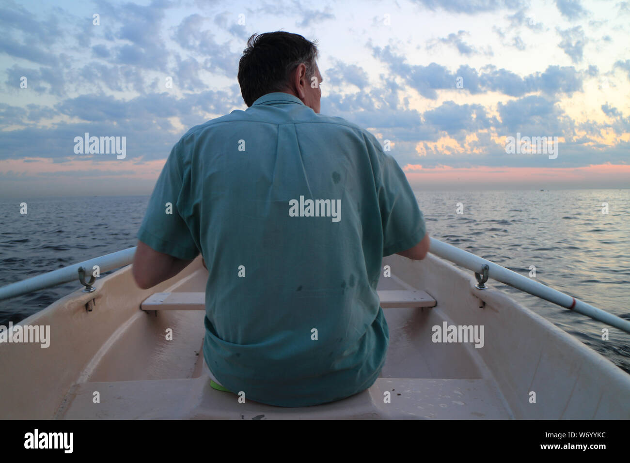 Man sitting on a boat hi-res stock photography and images - Alamy