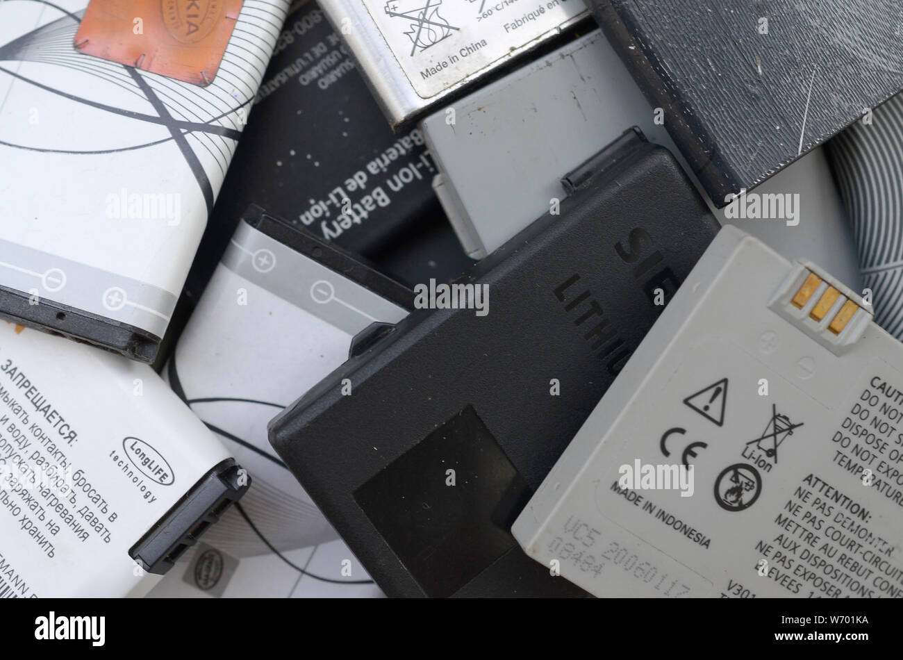 KHARKIV, UKRAINE JULY 30, 2019 Bunch of old used mobile phone batteries. Recycling