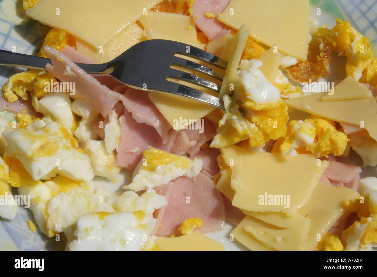 Ham and eggs. Healthy breakfast. Scrambled eggs and ham and cheese
