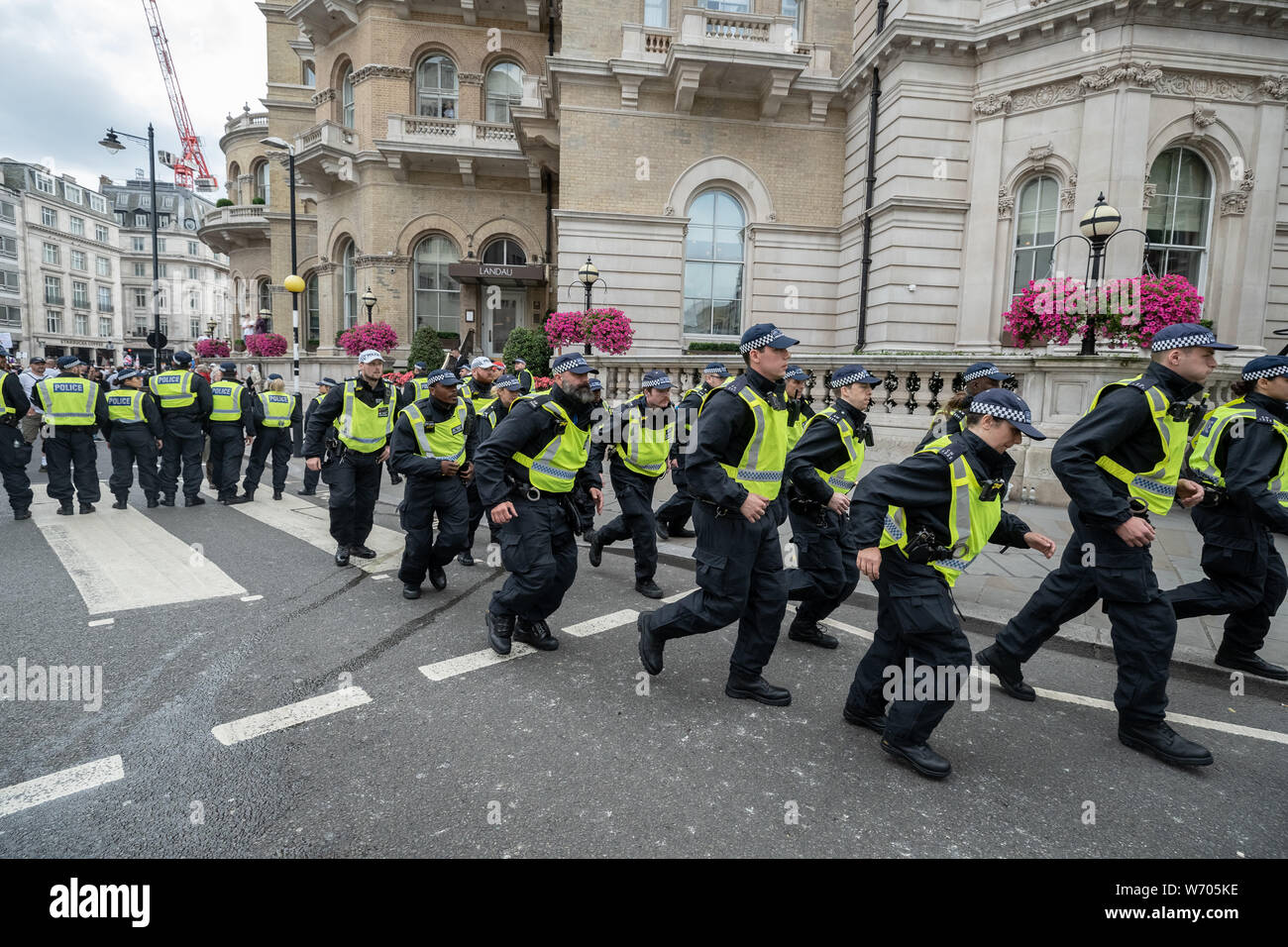 London, UK. 3rd August, 2019. 'Free Tommy Robinson' protest. Police arrest twenty four during a mass demonstration in support of the jailed Tommy Robinson, real name Stephen Yaxley-Lennon, who was sentenced last month to nine months in prison after being found guilty in contempt of court. Counter-protesters including antifascist activists and the anti-racist group: Stand Up to Racism, opposed the pro-Robinson demonstrators with protest groups kept apart by met police with some clashes. Credit: Guy Corbishley/Alamy Live News Stock Photo