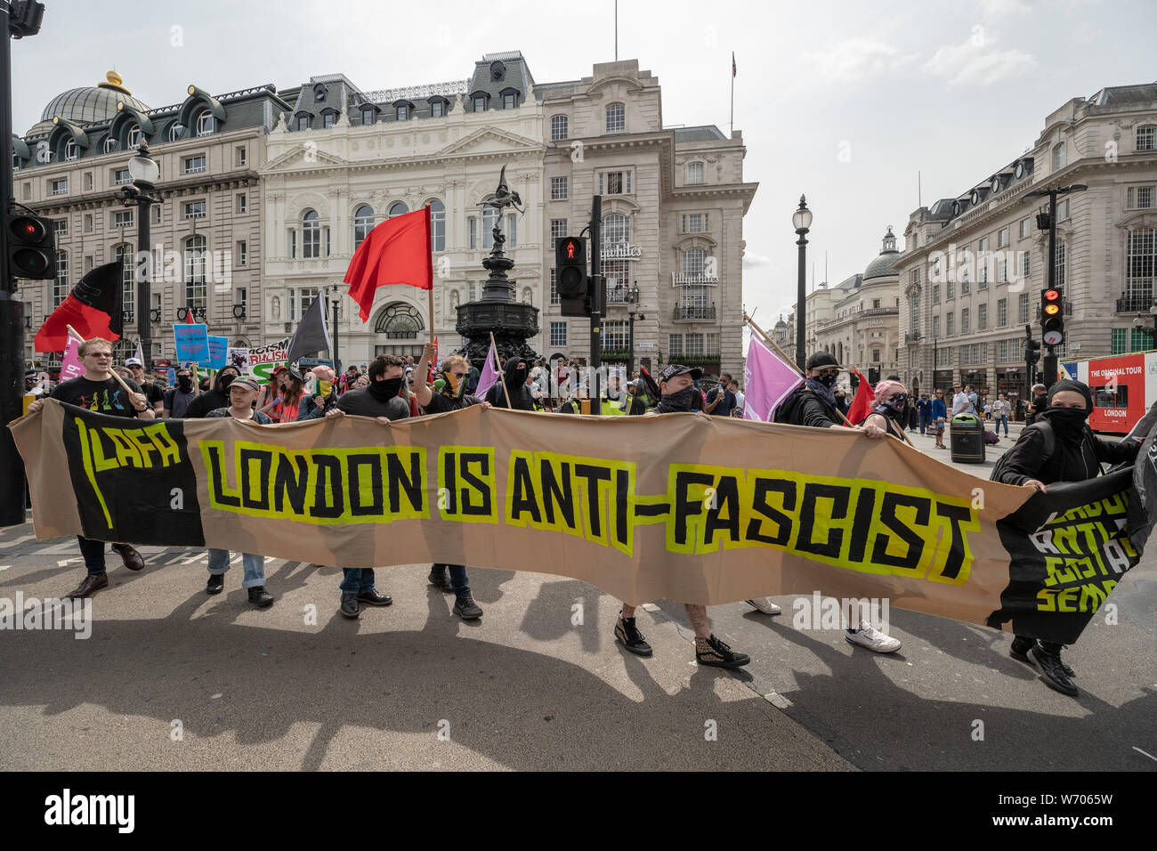 London, UK. 3rd August, 2019. Anti-fascists clash with police whilst counter-protesting the 'Free Tommy Robinson' demonstration. Police arrest twenty four during a mass demonstration in support of the jailed Tommy Robinson, real name Stephen Yaxley-Lennon, who was sentenced last month to nine months in prison after being found guilty in contempt of court. Counter-protesters including antifascist activists and the anti-racist group: Stand Up to Racism, opposed the pro-Robinson demonstrators with protest groups kept apart by met police. Credit: Guy Corbishley/Alamy Live News Stock Photo