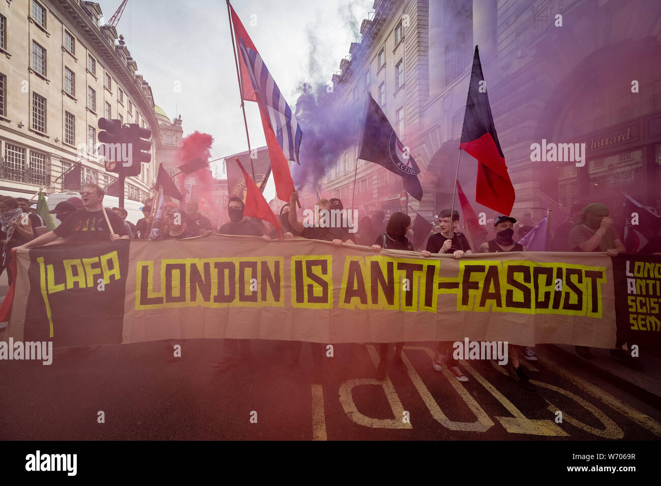 London, UK. 3rd August, 2019. Anti-fascists clash with police whilst counter-protesting the 'Free Tommy Robinson' demonstration. Police arrest twenty four during a mass demonstration in support of the jailed Tommy Robinson, real name Stephen Yaxley-Lennon, who was sentenced last month to nine months in prison after being found guilty in contempt of court. Counter-protesters including antifascist activists and the anti-racist group: Stand Up to Racism, opposed the pro-Robinson demonstrators with protest groups kept apart by met police. Credit: Guy Corbishley/Alamy Live News Stock Photo