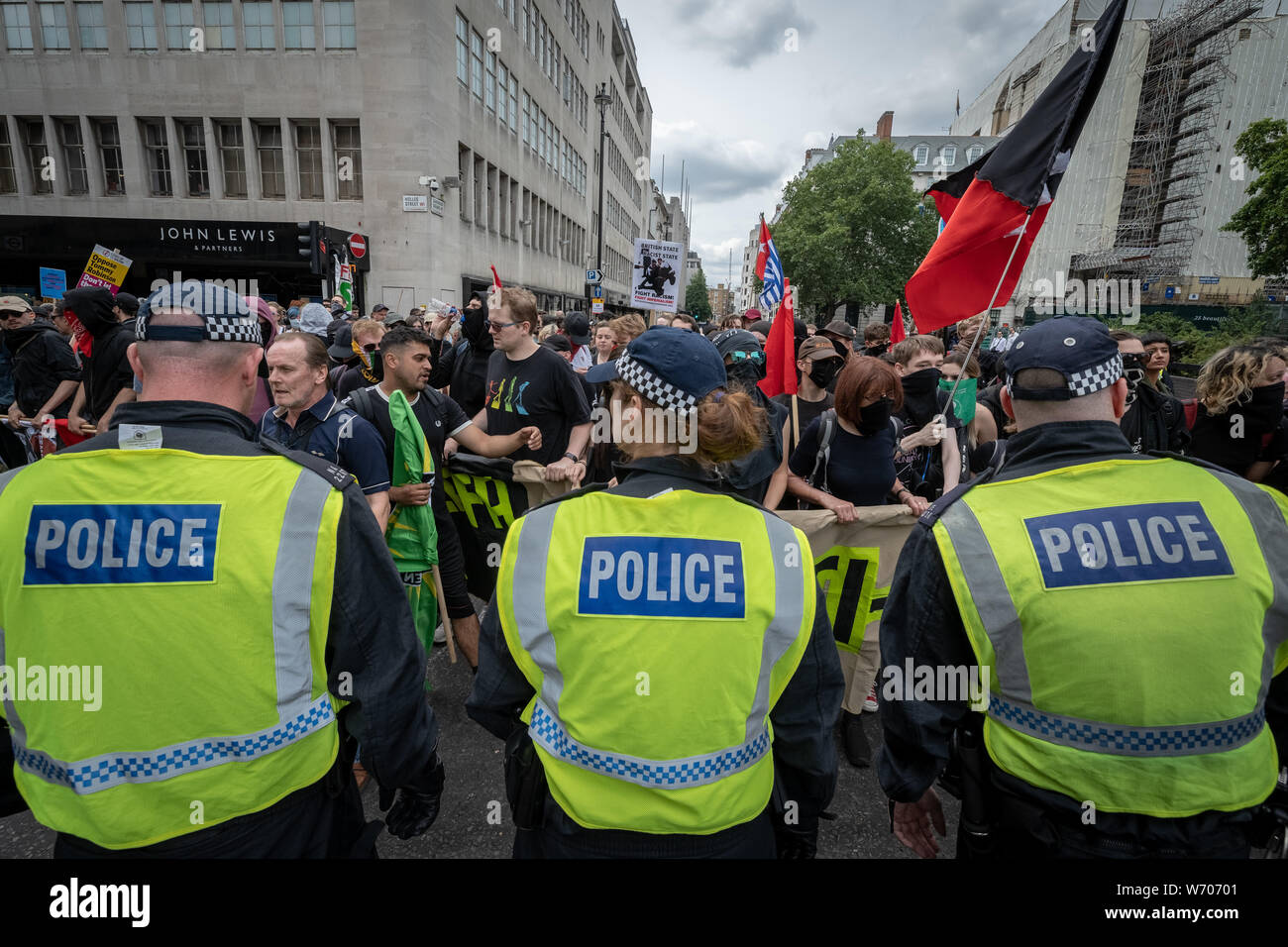 London, UK. 3rd August, 2019. Anti-fascists clash with police whilst counter-protesting the 'Free Tommy Robinson' demonstration. Police arrest twenty four during a mass demonstration in support of the jailed Tommy Robinson, real name Stephen Yaxley-Lennon, who was sentenced last month to nine months in prison after being found guilty in contempt of court. Counter-protesters including antifascist activists and the anti-racist group: Stand Up to Racism, opposed the pro-Robinson demonstrators with protest groups kept apart by met police. Credit: Guy Corbishley/Alamy Live News Stock Photo